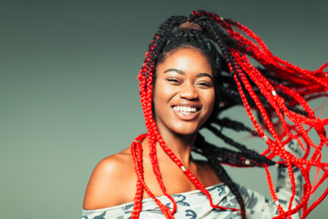 Portrait confident, carefree young woman with red braids