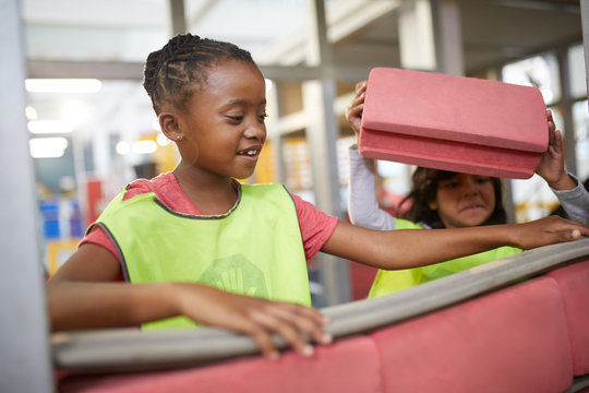 Girl playing foam bricks at construction exhibit in science center