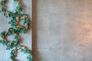 Greenery decor on gray wall perfect for text