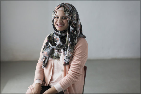 Portrait smiling, confident woman in floral hijab