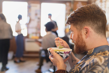 Businessman eating soup in office