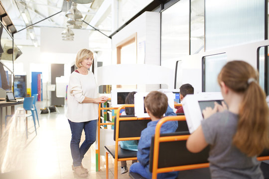 Teacher and students using touch screen computers