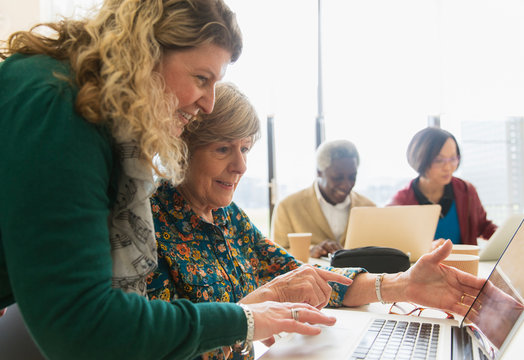 Businesswomen using laptop in conference room meeting