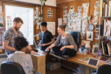 Creative designers playing cards in office