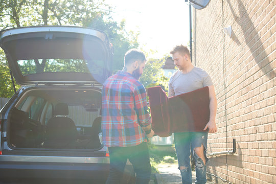 Male Gay Couple Moving Furniture