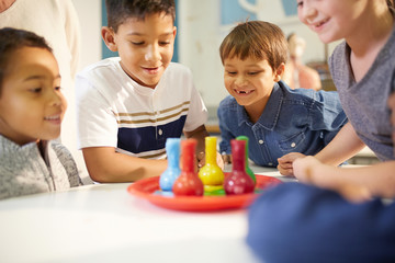 Curious kids watching foam in beakers