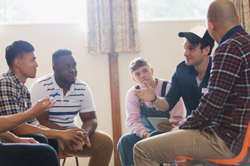 Men talking n group therapy circle