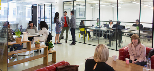Creative business people talking in open plan office