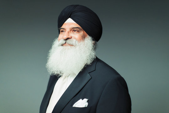 Portrait confident, well-dressed senior man with beard wearing turban