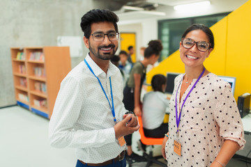 Portrait smiling, confident junior high teachers in library