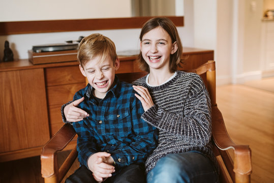 Portrait laughing tween brother and sister
