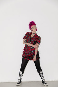 Portrait confident young woman with pink mohawk
