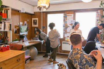 Creative designers with dogs in office