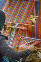Young woman working a backstrap loom
