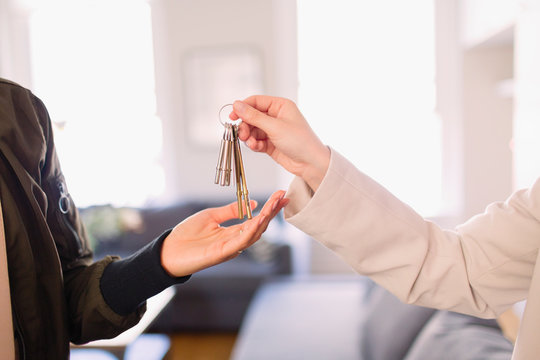 Real estate agent giving keys to homeowner