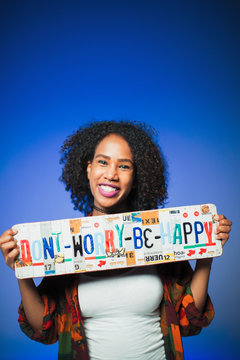 Portrait Smiling Woman Holding  Dont Worry Be Happy  License Plates