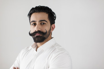 Portrait confident, serious young man with handlebar mustache