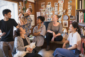 Creative designers with dogs meeting in office