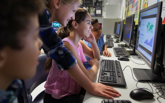 Junior high school students using computer in classroom