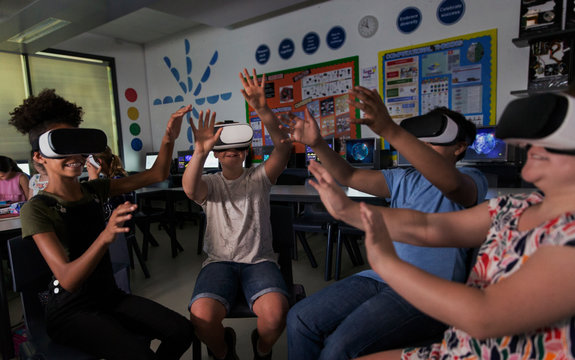 Junior high school students using virtual reality simulators in classroom