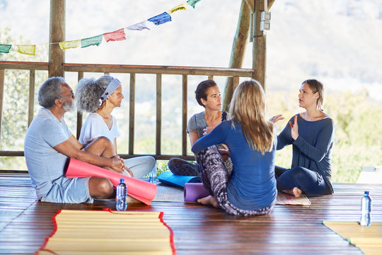Yoga Class Talking In Circle In Hut During Yoga Retreat