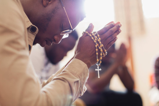 Man Praying With Rosary In Prayer Group