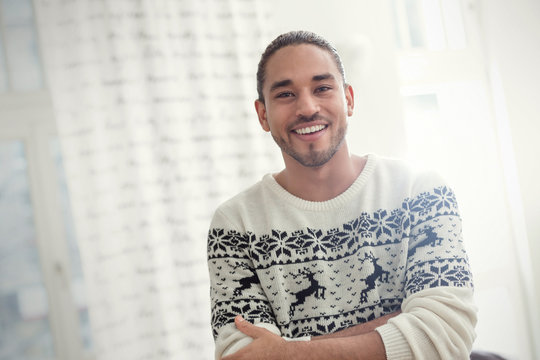 Portrait smiling, confident young man in Christmas sweater