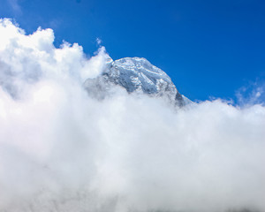 Top of the hill, covered with snow and white clouds