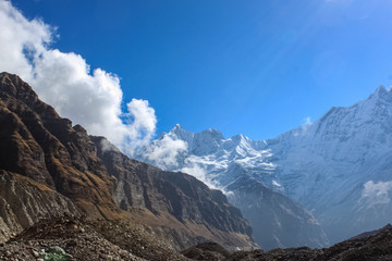 Top of the hill, covered with snow and white clouds
