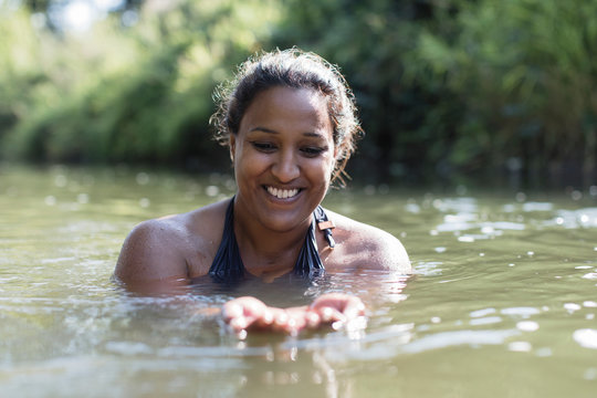 Happy woman swimming in river