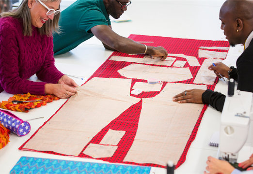 Fashion designers assembling sewing pattern