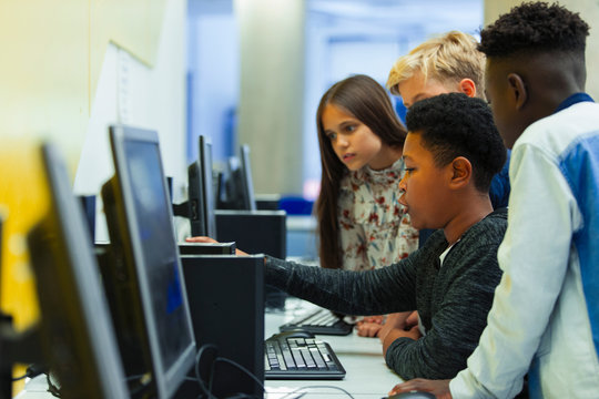 Junior high students using computer in computer lab
