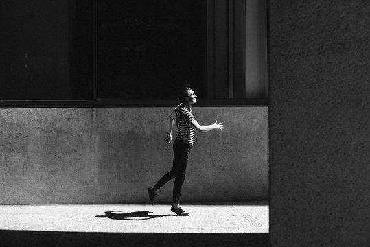 Young men stepping on urban pavement