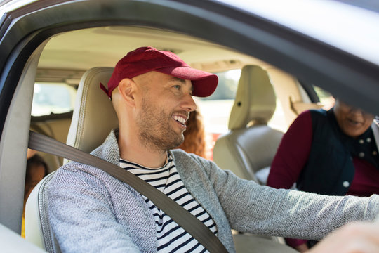 Smiling man driving car