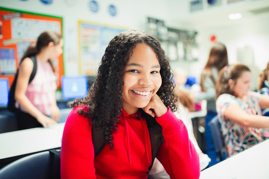 Portrait smiling, confident junior high school girl in classroom