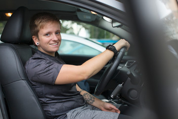 Portrait confident young woman in drivers seat