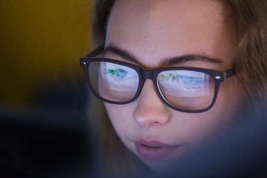 Focused girl in eyeglasses