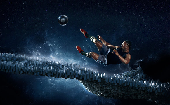 Male soccer player kicking soccer ball against futuristic background