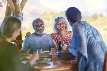 Happy senior couple enjoying breakfast on yoga retreat