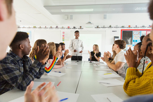 High school students clapping for classmate in debate class