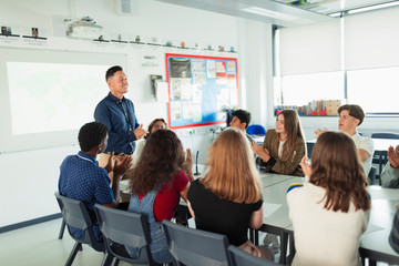 High school students clapping for teacher in debate class