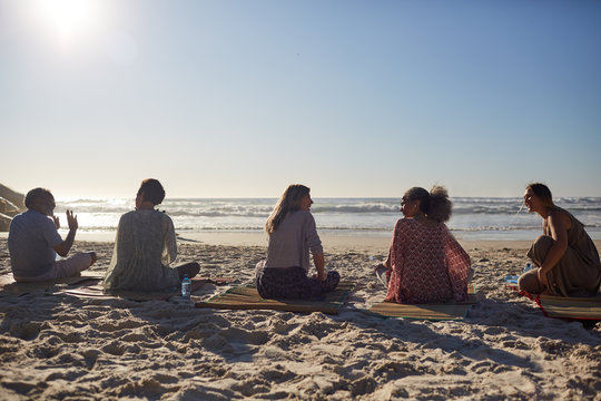 Yoga Class Talking On Sunny Beach During Yoga Retreat