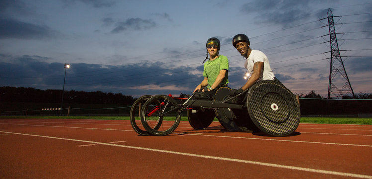 Portrait confident, paraplegic athletes on sports track, training for wheelchair race at night