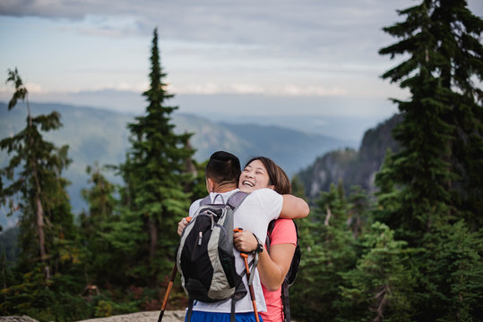 Happy couple hiking, hugging on mountain, Dog Mountain, BC, Canada