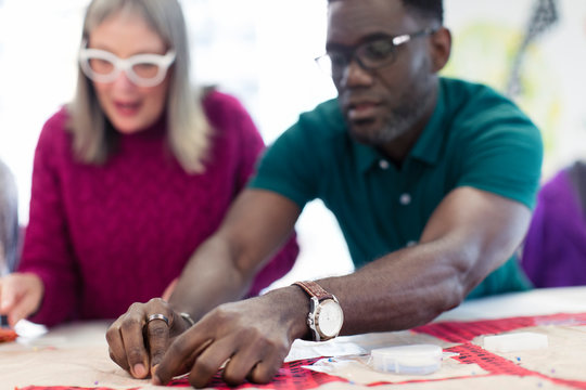 Fashion designers assembling sewing pattern
