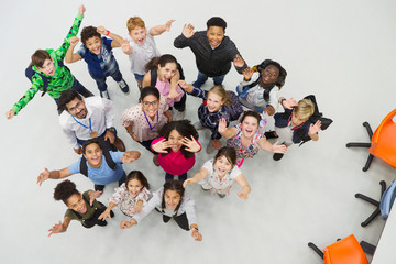 Portrait from above of enthusiastic junior high students teachers cheering