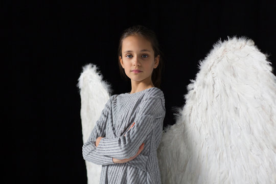 Portrait confident, brave girl wearing angel wings
