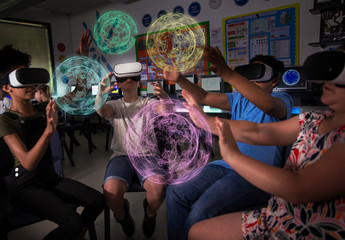 Junior high school students using virtual reality simulators in dark classroom