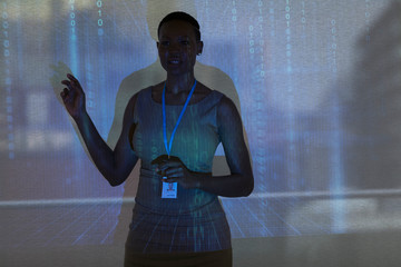 Businesswoman leading meeting at projection screen with binary code