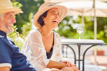 Woman laughing at sunny resort poolside
